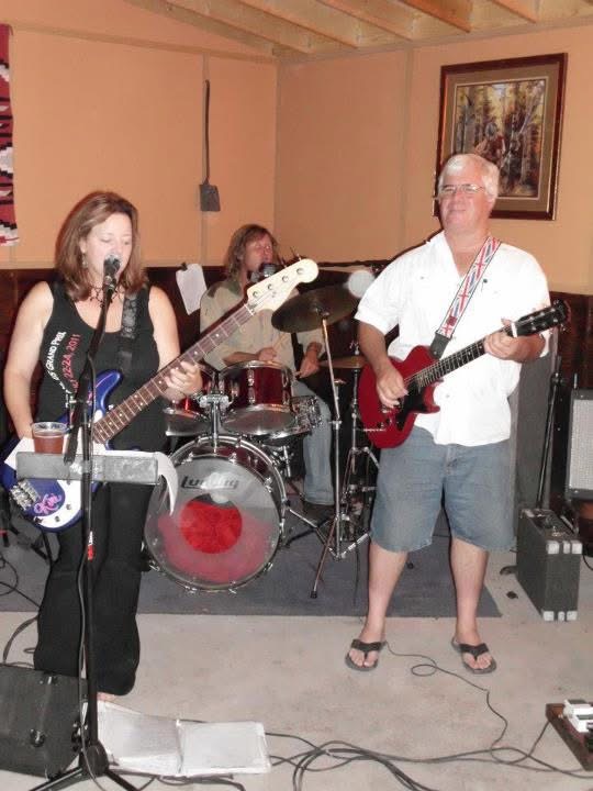 The full band playing on stage together