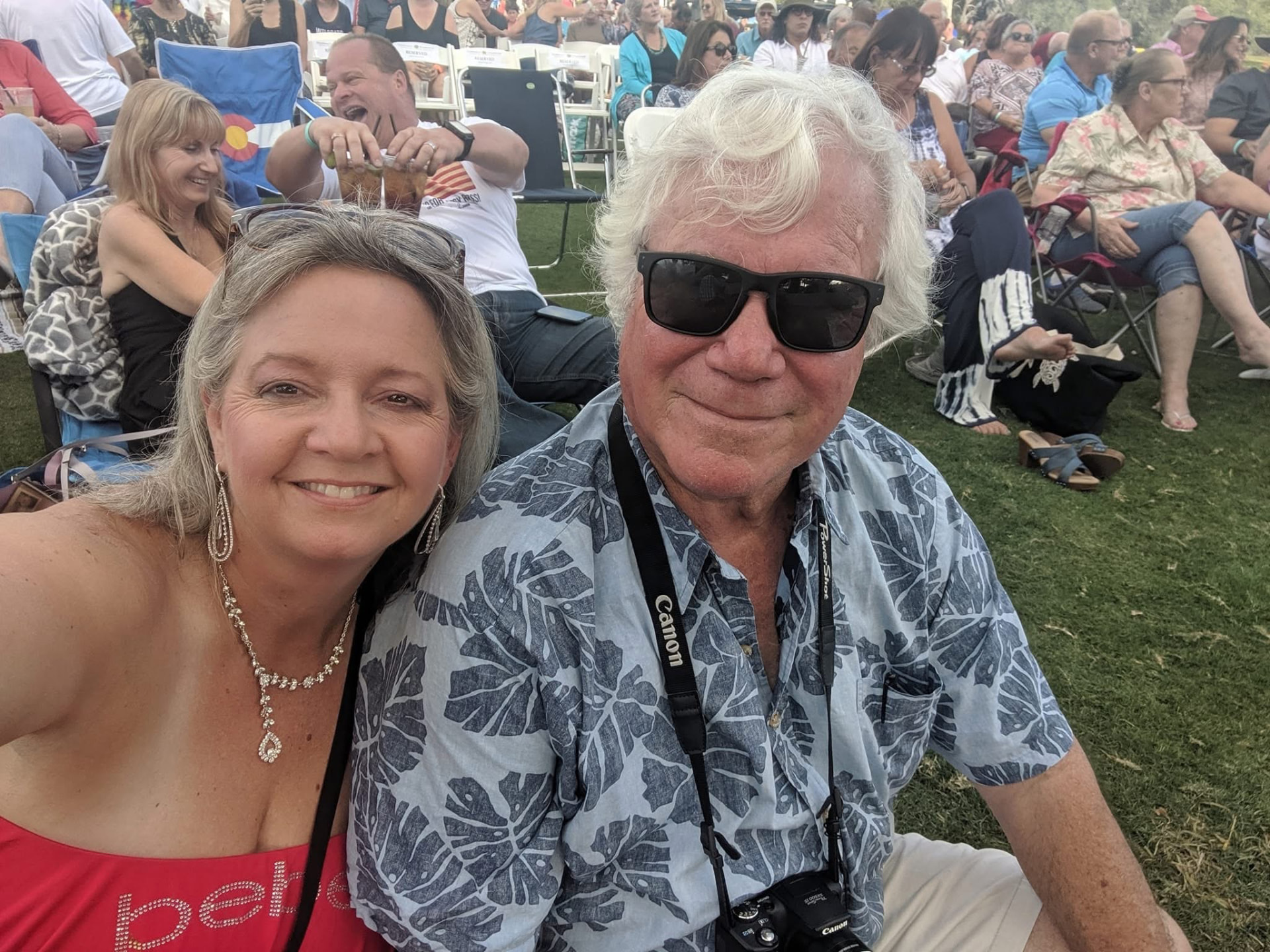 Kiri and Greg relaxing at an outdoor concert